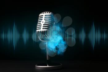 Retro microphone with radio waves on dark background�