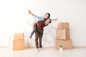 Young couple near cardboard boxes after moving into new house�