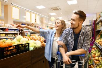 Young couple choosing food in supermarket�