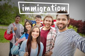 Group of immigrants with USA flags taking selfie outdoors�