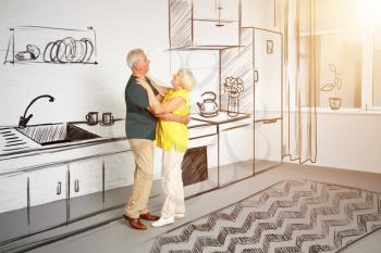 Happy mature couple dancing in their future house�