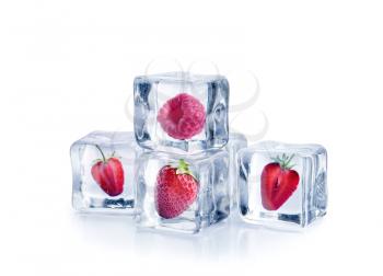 Ice cubes with strawberries and raspberry on white background�