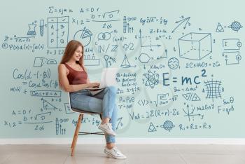 Young woman with laptop studying exact mathematical sciences. Concept of online education�