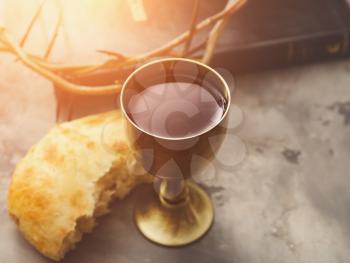 Chalice of wine and bread on grunge background�