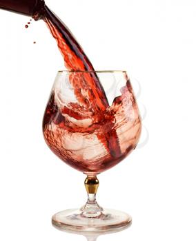 red wine being poured into a wine glass
