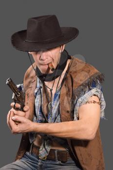 cowboy with revolver isolated on grey background.Shallow DOF