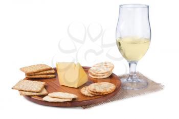 some crackers on the wooden plate and wine isolated on white background
