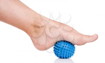 Woman's foot with spiny plastic blue massage ball isolated on white background