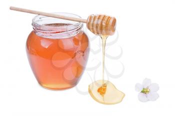 glass jar with honey and wooden stick isolated on white background 