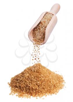heap of brown sugar and wooden scoop on white background