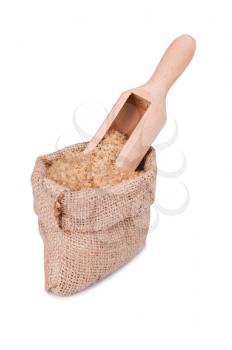 Burlap bag with brown sugar cane on white background