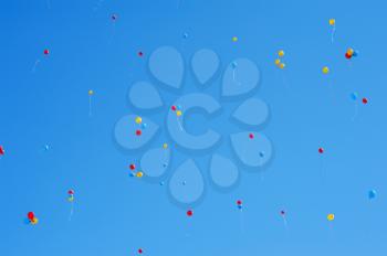 a lot of balloons in the blue sky