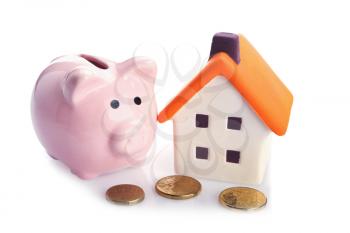 conceptual image with piggy  bank, coin and house