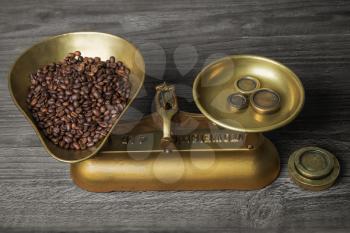 old retro scales on old wooden table with coffee beans