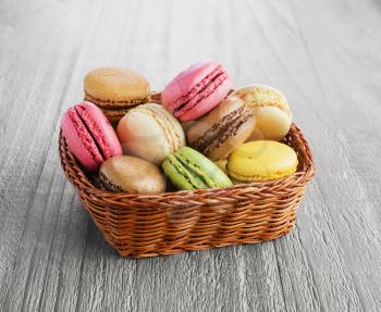 Colorful and tasty French Macaroons on the wicker basket