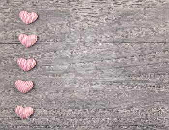 wooden background with gingham hearts toning in vintage style 