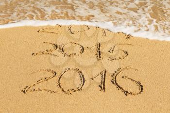 digits  2014,2015 and 2016 on the sand seashore - concept of new year and passing time