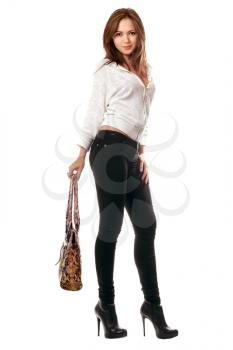 Royalty Free Photo of a Woman in Tight Pants Holding a Handbag