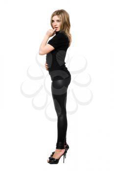 Royalty Free Photo of a Woman in Leggings and Heels Standing to the Side