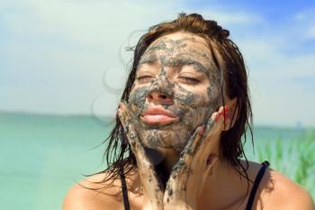 Royalty Free Photo of a Woman With Mud on Her Face