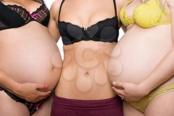 Royalty Free Photo of a Woman Between Two Pregnant Women