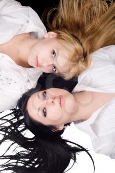 Royalty Free Photo of Two Women Lying With Their Heads Together