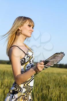 Royalty Free Photo of a Woman With a Fan in Her Hand