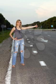 Royalty Free Photo of a Woman Hitchhiking