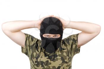 Royalty Free Photo of a Man Wearing a Balaclava With His Hands Behind His Head
