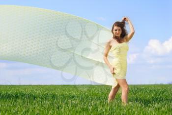 Pretty young woman in a green field