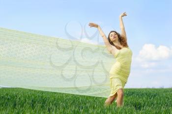 Attractive young woman in a green field