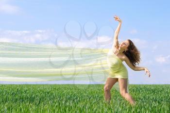 Expressive flexible young woman in a green field 