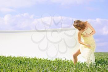 Expressive cute girl in a green field 