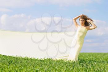 Expressive beautiful girl in a green field 