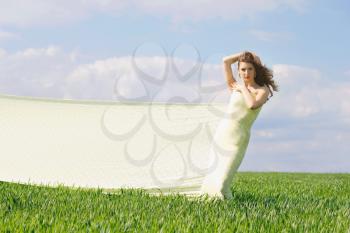 Expressive attractive girl in a green field 