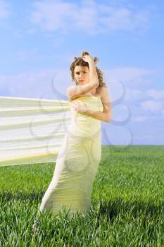 Young beautiful woman wrapped in yellow cloth