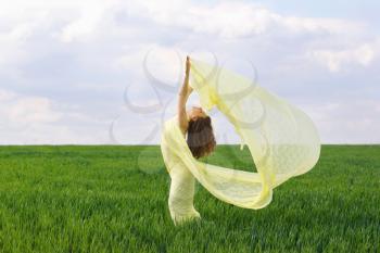 Perfect girl dancing in a green field