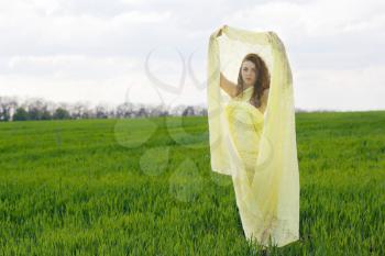 Perfect young woman wrapped in yellow cloth