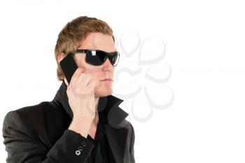 Young man in black talking on the mobile phone. Isolated