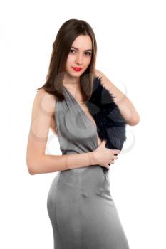 Alluring young woman wearing grey dress with fur. Isolated on white