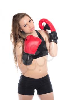 Portrait of young blonde posing in black sportswear with red boxing gloves. Isolated on white