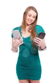 Portrait of funny blond woman with two smartphones. Isolated on white