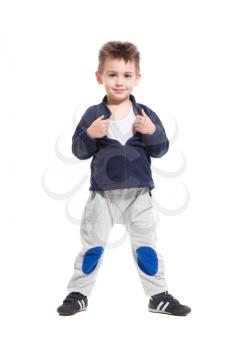 Smiling little boy posing in sport clothes. Isolated on white