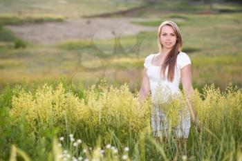 Sweet blond woman posing on the meadow