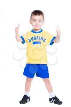 Nice little boy posing in Ukrainian football uniform. Isolated on white