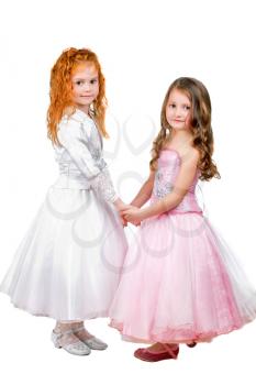 Little girls in nice dresses holding each others hands. Isolated on white