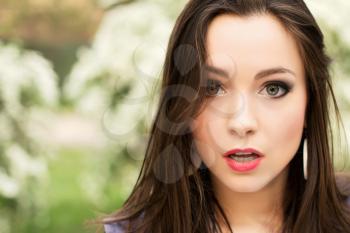 Portrait of young pretty brunette with surprised face
