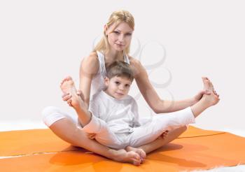 Royalty Free Photo of a Mother and Song Practicing Yoga