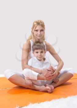 Royalty Free Photo of a Mother and Son Practicing Yoga