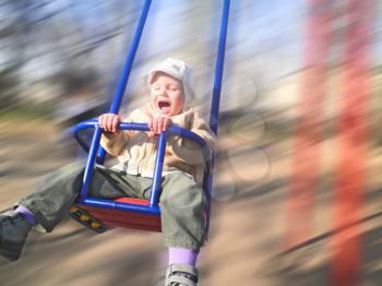 Royalty Free Photo of a Kid on a Swing